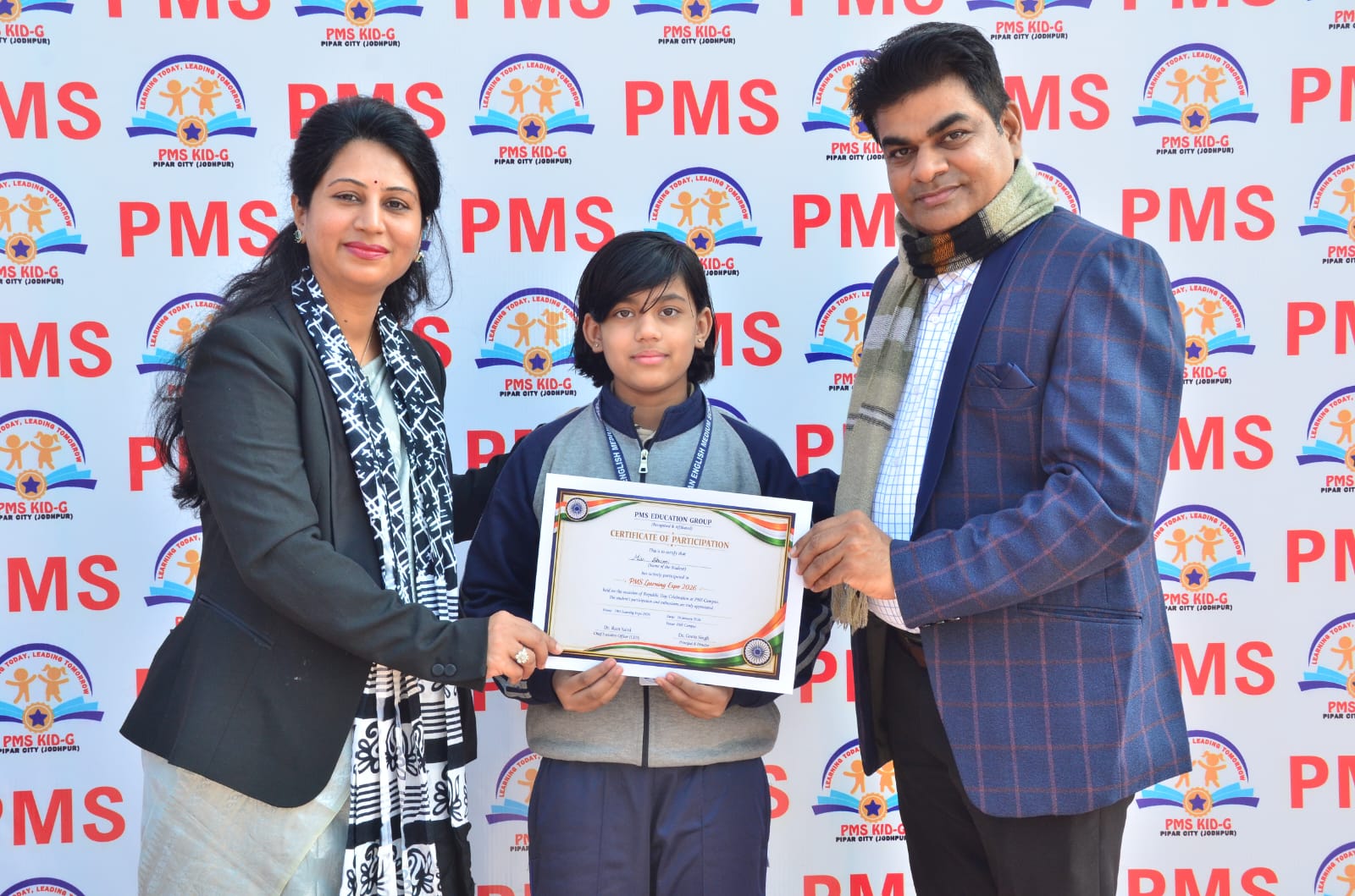 PMS students and staff with award certificate